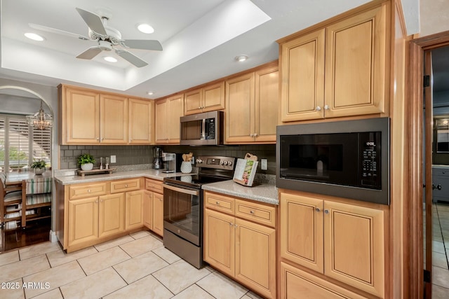 kitchen with backsplash, appliances with stainless steel finishes, light tile patterned flooring, and light brown cabinets