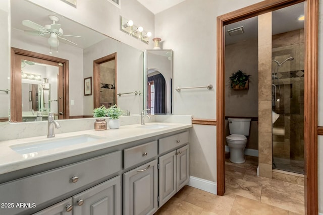 bathroom with a sink, ceiling fan, and a tile shower