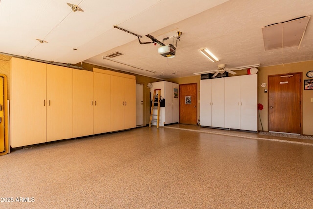 garage featuring visible vents and a garage door opener