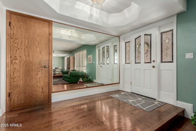 entrance foyer with baseboards and wood finished floors