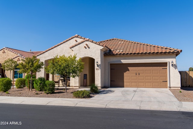 mediterranean / spanish-style house with a garage