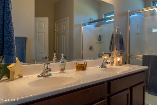 bathroom with walk in shower and vanity