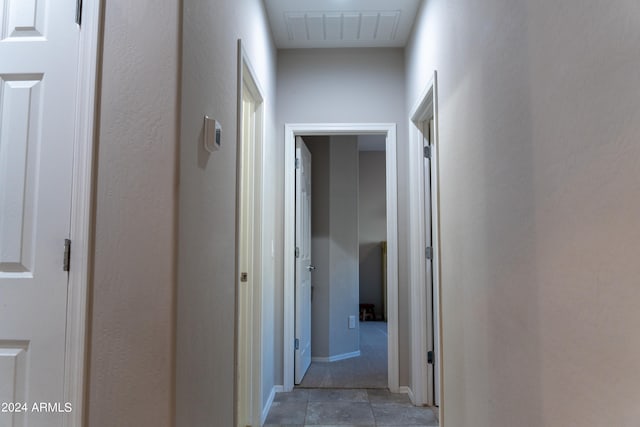 corridor featuring light tile patterned floors