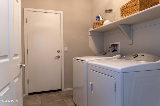 laundry room featuring light tile patterned flooring and washer and clothes dryer