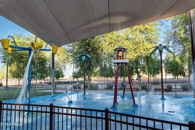 view of playground with a community pool