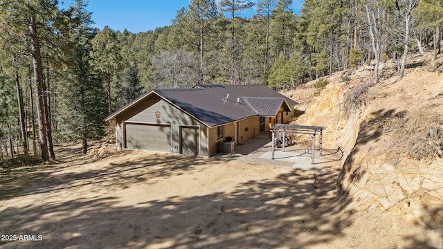 view of front facade with a garage and cooling unit