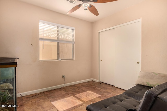 1507 W Mesquite Ave, Apache Junction, AZ 85120 - living area featuring a ceiling fan, baseboards, and stone finish floors