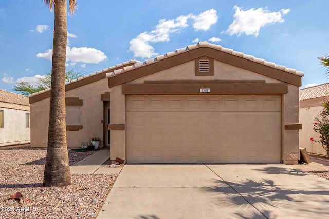 1507 W Mesquite Ave, Apache Junction, AZ 85120 - pueblo-style house featuring stucco siding, driveway, an attached garage, and a tiled roof