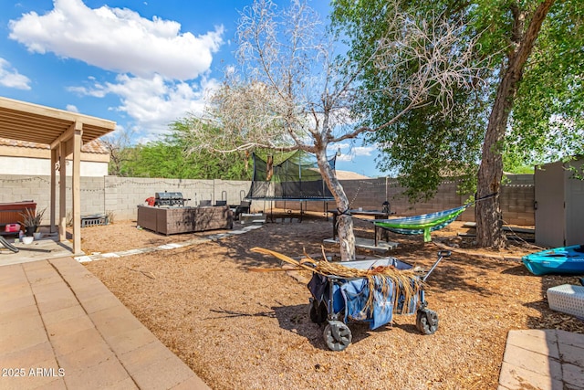 1507 W Mesquite Ave, Apache Junction, AZ 85120 - fenced backyard with a trampoline, outdoor lounge area, and a patio area