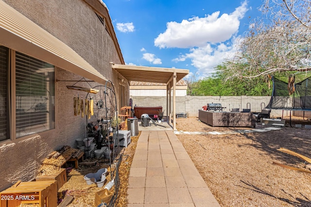 1507 W Mesquite Ave, Apache Junction, AZ 85120 - fenced backyard with a trampoline, a patio area, and an outdoor living space