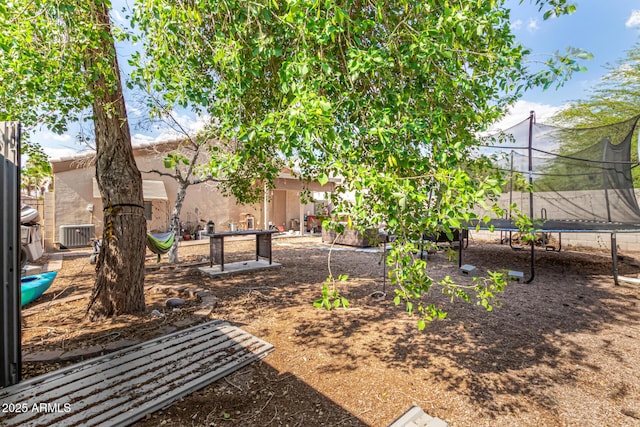 1507 W Mesquite Ave, Apache Junction, AZ 85120 - view of yard featuring a trampoline and central AC