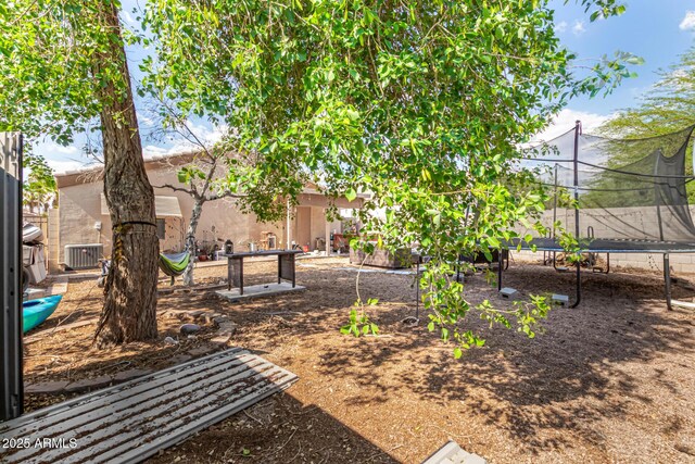 1507 W Mesquite Ave, Apache Junction, AZ 85120 - view of yard featuring a trampoline and central AC