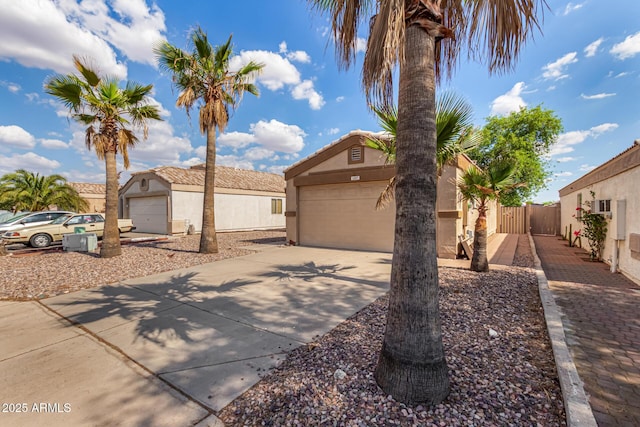1507 W Mesquite Ave, Apache Junction, AZ 85120 - view of front of home with stucco siding, concrete driveway, and an outbuilding