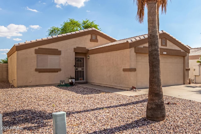 1507 W Mesquite Ave, Apache Junction, AZ 85120 - view of front of house featuring driveway, a garage, stucco siding, and a tile roof
