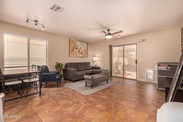 1507 W Mesquite Ave, Apache Junction, AZ 85120 - living area with a ceiling fan, light stone finish floors, and baseboards
