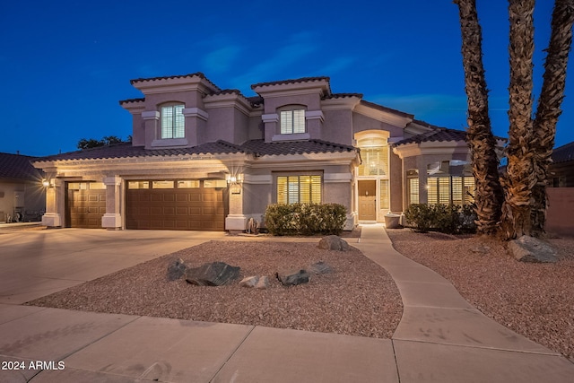 mediterranean / spanish-style home with a garage