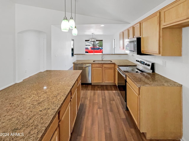 kitchen with dark wood-type flooring, vaulted ceiling, an inviting chandelier, sink, and appliances with stainless steel finishes