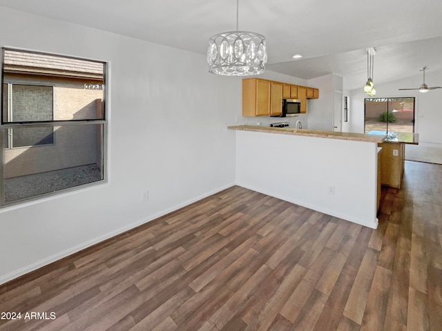 kitchen featuring dark hardwood / wood-style flooring, light brown cabinets, kitchen peninsula, and vaulted ceiling