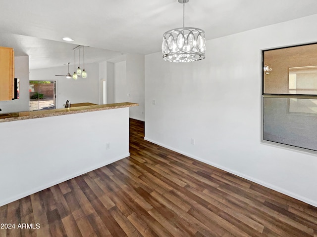 unfurnished room with lofted ceiling and dark hardwood / wood-style flooring