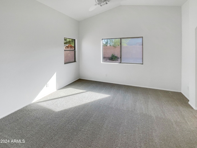 carpeted empty room with lofted ceiling and ceiling fan