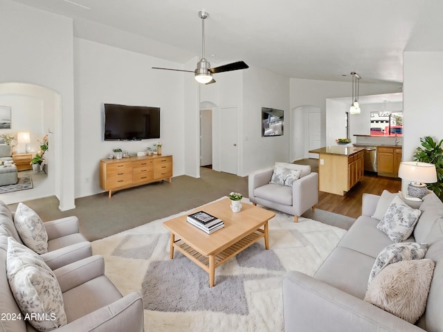 living room with ceiling fan and light hardwood / wood-style flooring