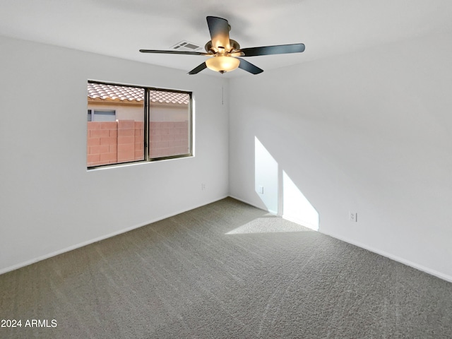 carpeted spare room featuring ceiling fan