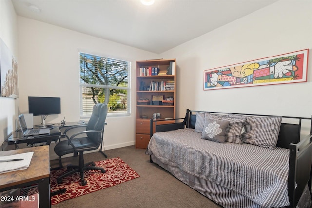 carpeted bedroom with lofted ceiling