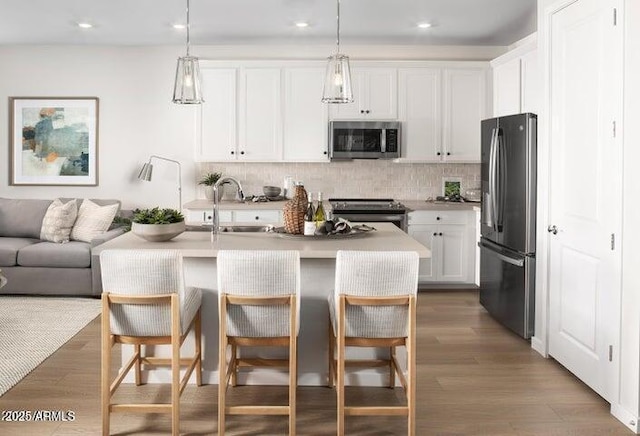 22376 W Monona Ln, Surprise, AZ 85387 - kitchen with appliances with stainless steel finishes, tasteful backsplash, a sink, open floor plan, and recessed lighting