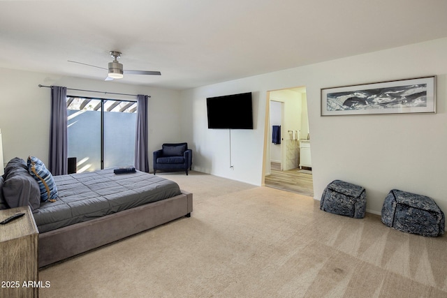 bedroom featuring ceiling fan, connected bathroom, and light colored carpet