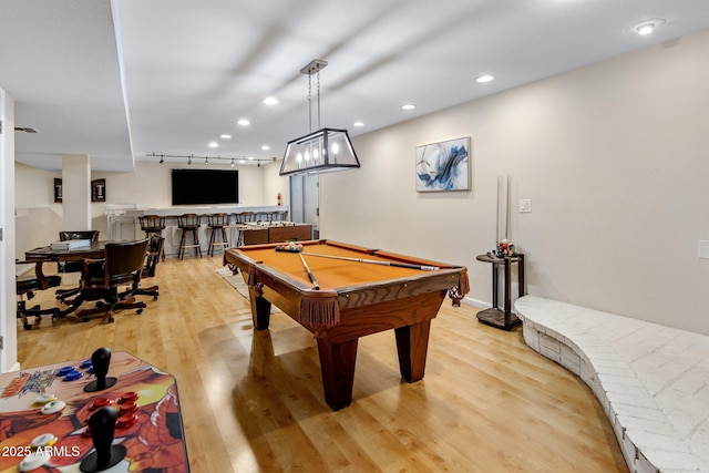 rec room featuring pool table, light hardwood / wood-style flooring, rail lighting, and bar area