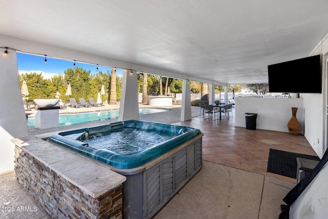 view of patio featuring a pool with hot tub