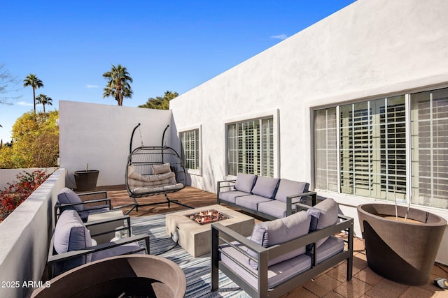 view of patio featuring an outdoor living space with a fire pit