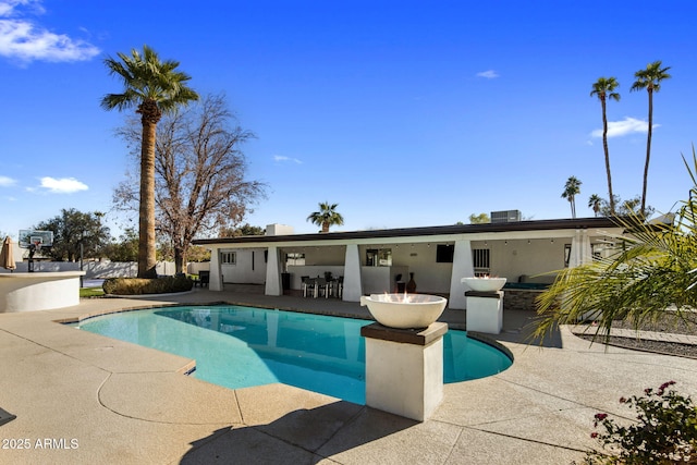 view of pool featuring a patio and a bar