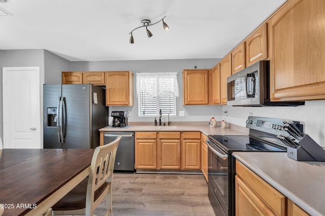 2412 W Camp River Rd, San Tan Valley, AZ 85144 - kitchen with light wood-style flooring, stainless steel appliances, light countertops, and a sink