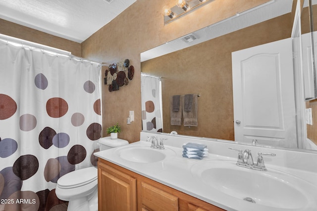 2412 W Camp River Rd, San Tan Valley, AZ 85144 - bathroom with toilet, visible vents, a sink, and double vanity
