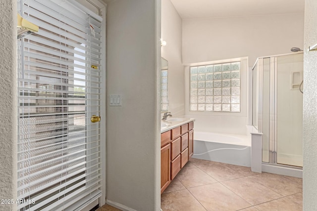 bathroom with a shower stall, a bath, vanity, and tile patterned flooring
