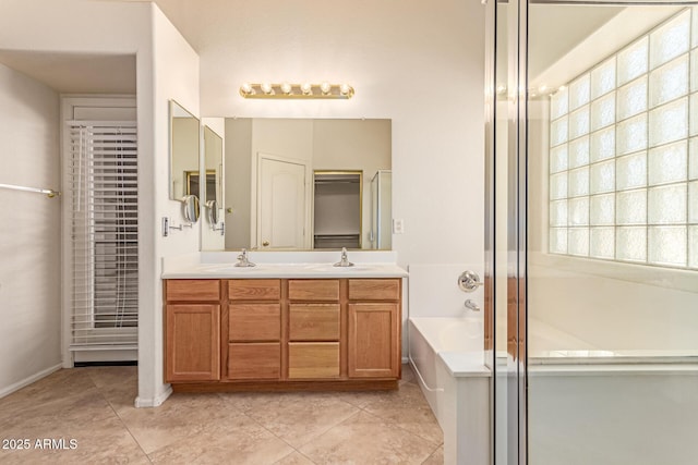 bathroom with a bath, double vanity, tile patterned flooring, and a shower with door