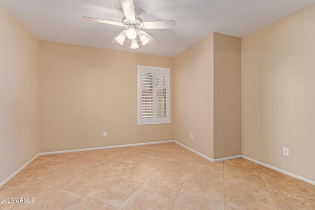 unfurnished room with ceiling fan, light tile patterned flooring, and baseboards