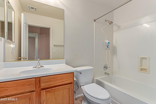 bathroom featuring vanity, toilet, and  shower combination