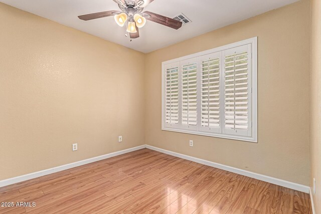 unfurnished room with wood finished floors, baseboards, and ceiling fan