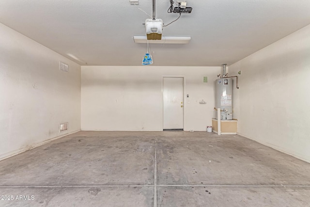 garage with gas water heater and a garage door opener