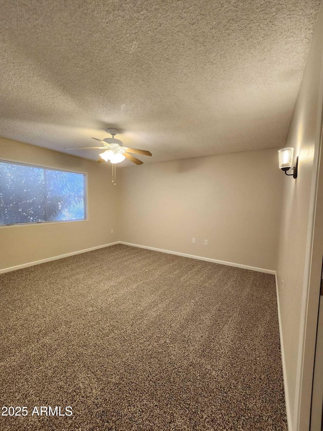 unfurnished room with carpet floors, a ceiling fan, a textured ceiling, and baseboards