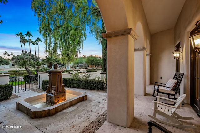 view of patio terrace at dusk