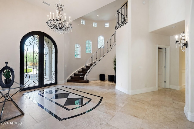 foyer featuring a towering ceiling and french doors