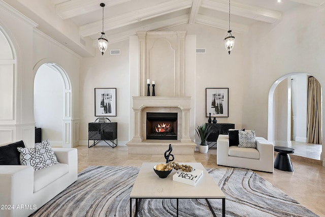 living room with beamed ceiling, a high end fireplace, and high vaulted ceiling