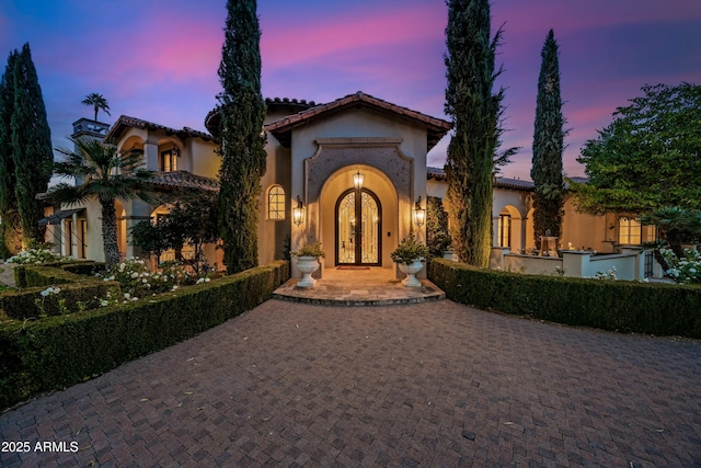 mediterranean / spanish-style home with french doors