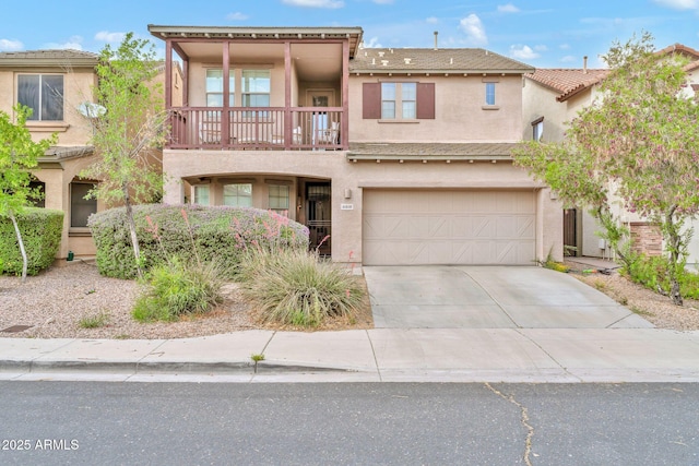 view of front of home with a balcony, stucco siding, driveway, and a garage