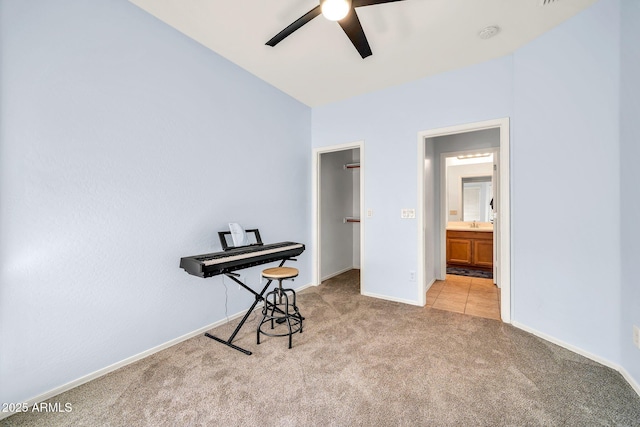 carpeted bedroom featuring baseboards and a ceiling fan