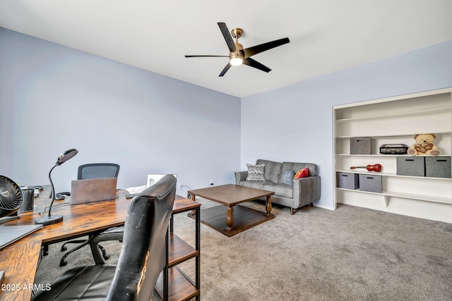 carpeted home office with a ceiling fan