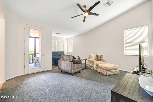 living room featuring ceiling fan, carpet flooring, baseboards, and vaulted ceiling